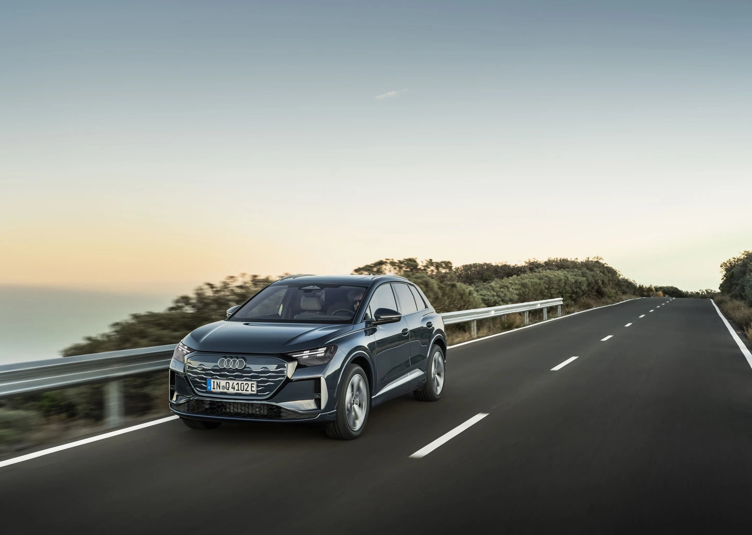 Audi Q4 SUV e-tron - Plasma blue, outdoor dynamic photo, exterior, three-quarter front view