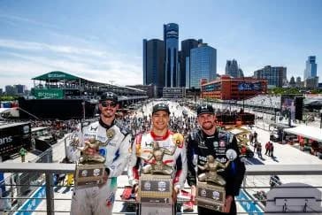 #10: Alex Palou, Chip Ganassi Racing Honda, #27: Kyle Kirkwood, Andretti Global Honda, #15: Graham Rahal, Rahal Letterman Lanigan Racing Honda celebrate on the podium