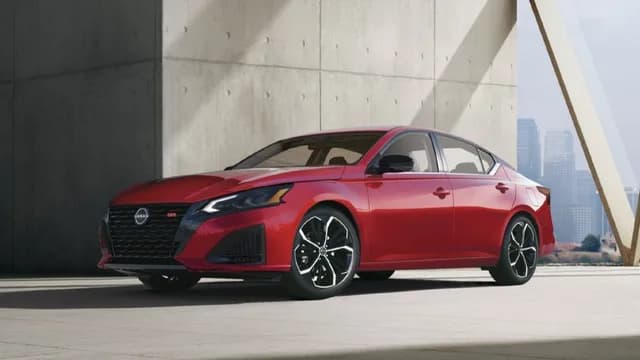 Front left 3/4 view of the 2027 Nissan Altima parked in front of a concrete wall.