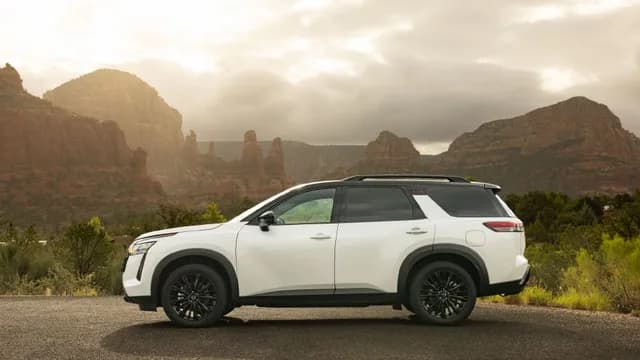 Left profile view of the 2027 Nissan Pathfinder Special Edition overlooking a canyon on a foggy day.