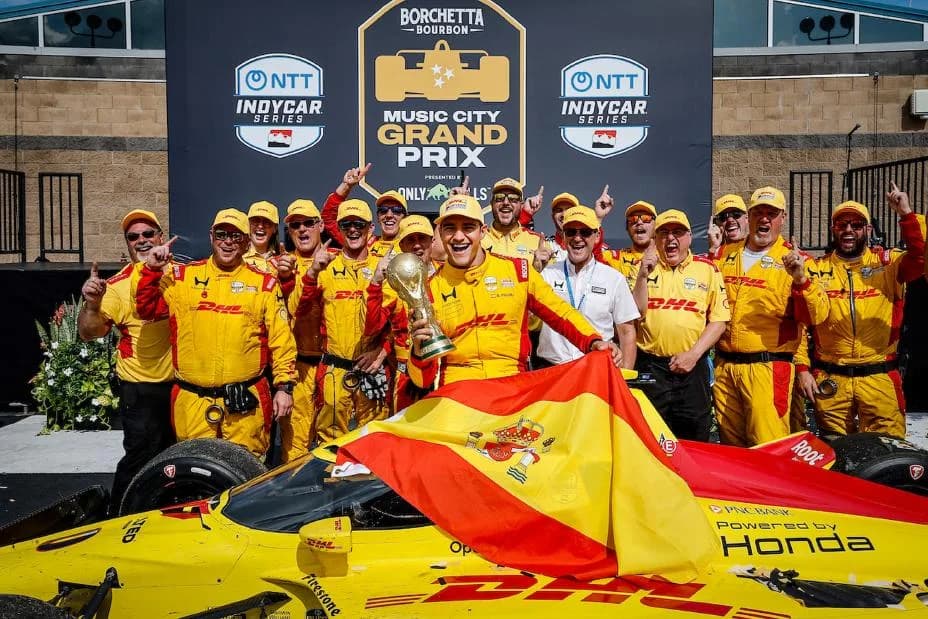 Winner #10: Alex Palou, Chip Ganassi Racing Honda celebrates with his team, World Cup Trophy, and the flag of World Cup winners Spain in Victory Lane