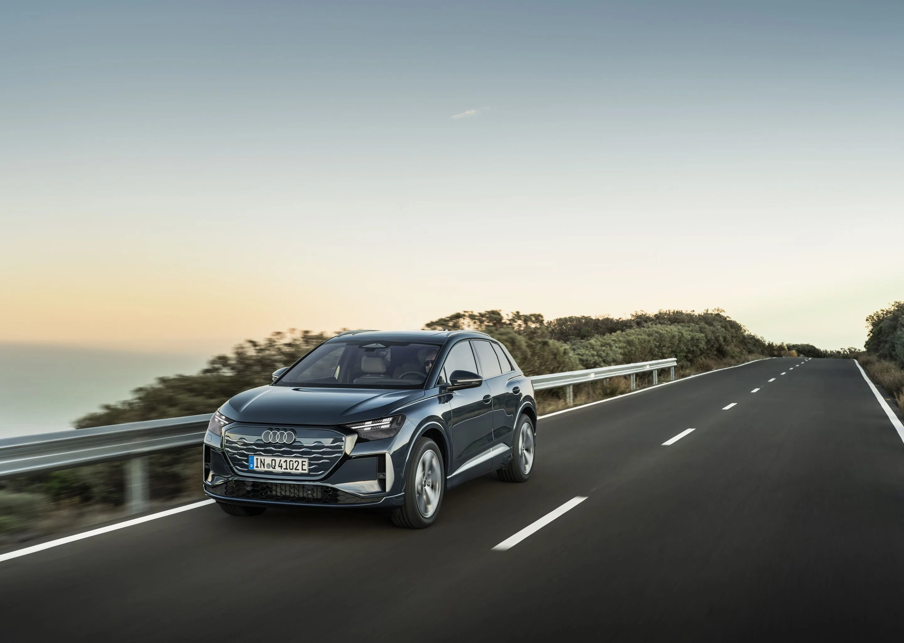 Audi Q4 SUV e-tron - Plasma blue, outdoor dynamic photo, exterior, three-quarter front view