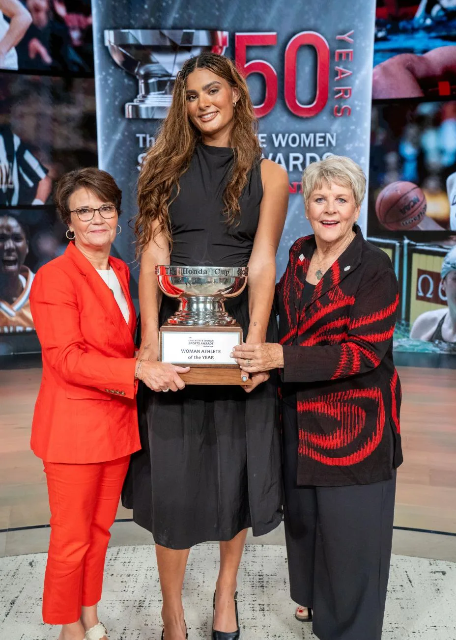 Honda Chief Inclusion & Impact Officer Elly Bradford, 2026 Honda Cup Winner Lauren Betts, and The Collegiate Women Sports Awards Executive Director Chris Voelz. c) Dare to Be Films/CWSA.