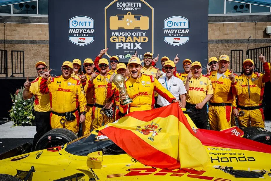 Winner #10: Alex Palou, Chip Ganassi Racing Honda celebrates with his team, World Cup Trophy, and the flag of World Cup winners Spain in Victory Lane