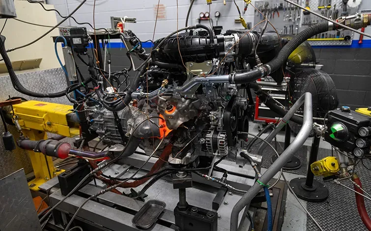 An engine on a table in a factory plant setting.