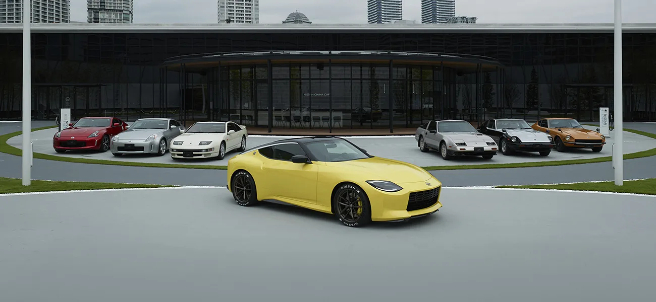 A yellow Z parked in front of 6 other Nissan Zs.