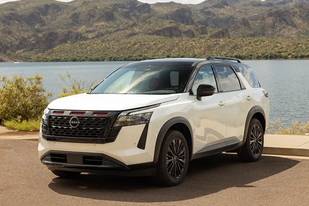Front left 3/4 view of the 2027 Nissan Pathfinder Special Edition parked in front of a body of water.